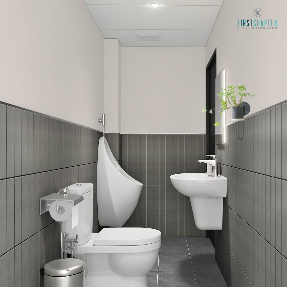 Narrow restroom with dark grey vertical tiles, urinal, toilet, wall-hung basin, lit mirror and hanging plant