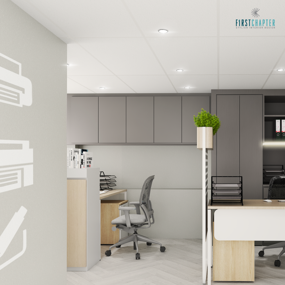 Open office workstations with grey overhead cabinets, ergonomic chairs and printer pictograms on the wall