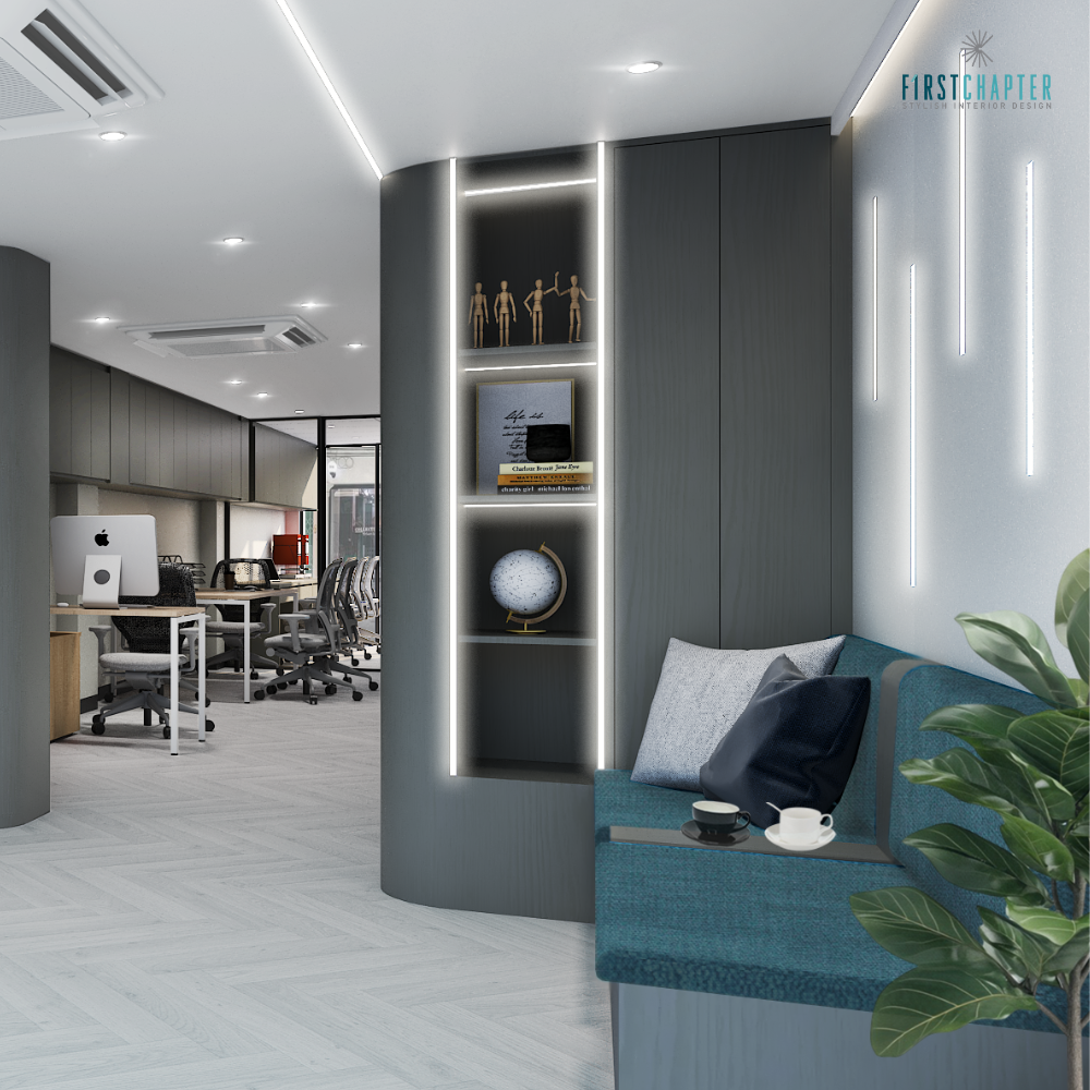 Reception lounge with teal sofa, curved dark grey wall, lit display niche, vertical LED wall strips and view to open workstations